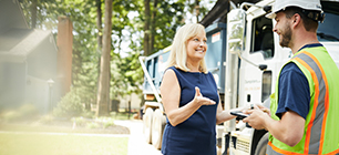 Homeowner talking to Dumpsters.com driver.