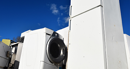 A Washing Machine and Refrigerator with a Blue Sky in the Background.