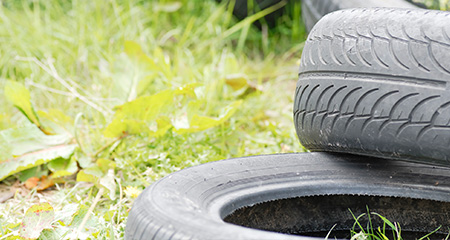 A Pile of Tires in the Grass.