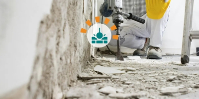 Worker Using Jackhammer to Demolish Floor