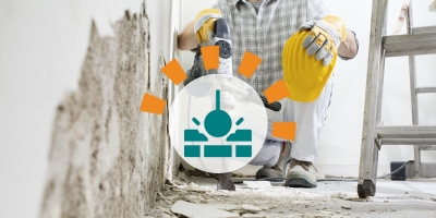 Worker Using Jackhammer to Demolish Floor