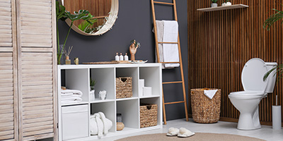 A dark accent wall in a modern decorated bathroom. 