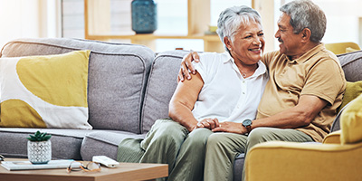 A senior couple in their living room after aging in place modifications. 