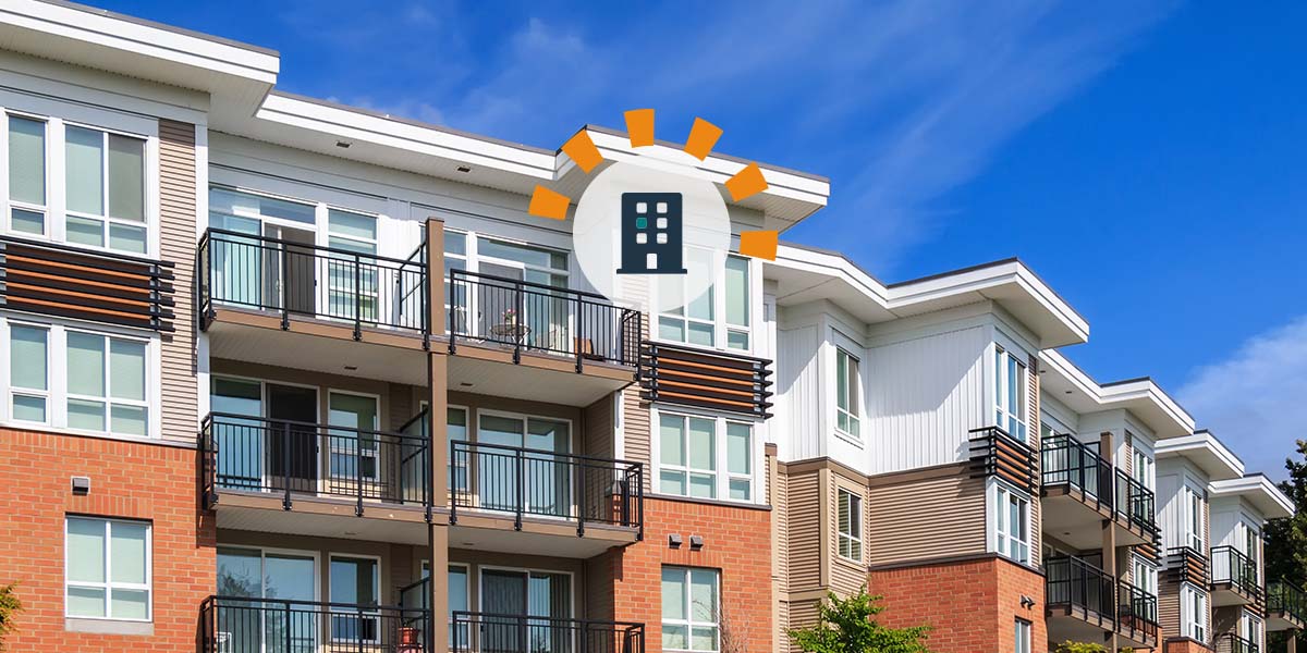 Multi-story, brick apartment building complex with balconies. 