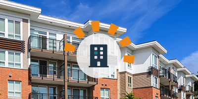 Multi-story, brick apartment building complex with balconies. 