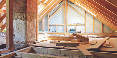 Bare attic with floorboards and no insulation.