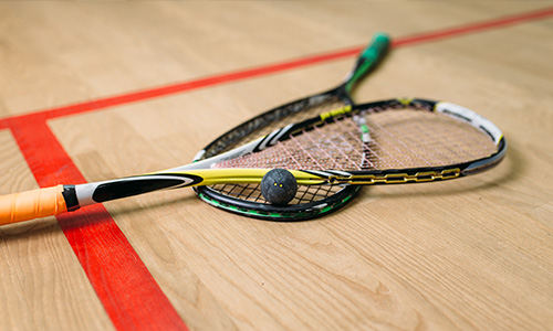 A set of racquetball racquets inside a barn. 