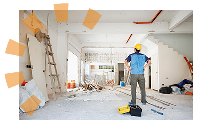 A man in safety gear assessing his home renovation. 