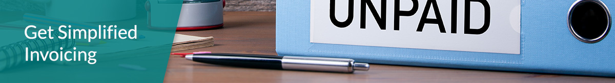 A light blue binder with “Unpaid” written on its side lying on a desk next to a coffee mug, a rubber stamp, a pen and a notebook.
