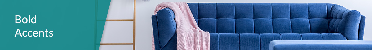 Blue Velvet Couch With Pink Blanket and Decorative Ladder in White Room.