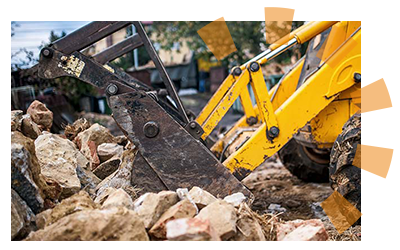 A bulldover pushing cement debris