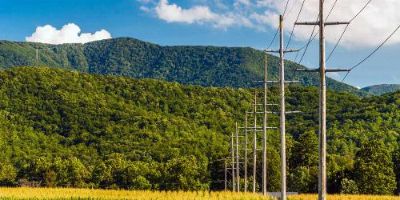Power Lines Leading Towards Mountains
