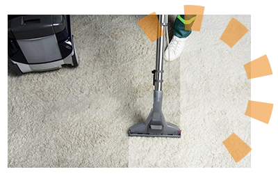 A professional carpet cleaner vacuuming carpet after a renter moves out. 