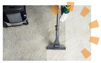 A professional carpet cleaner vacuuming carpet after a renter moves out.