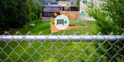 The backyard of a home with chain link fencing.