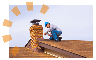 A worker applies caulk to a brick chimney.