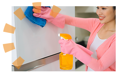 A woman in rubber gloves cleaning a refrigerator. 