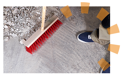 A red broom sweeping up demolished plaster and lath. 