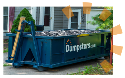 A blue dumpster with concrete debris. 