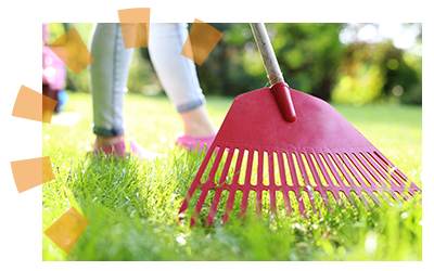 A red rake in a yard.