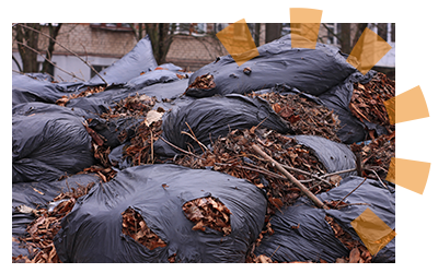 Trash bags bursting with yard waste.