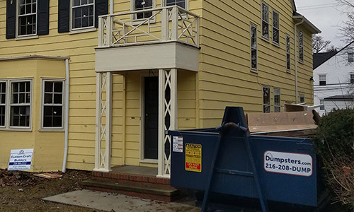 A home restored by the Cleveland Restoration Society with a Dumpsters.com dumpster out front.