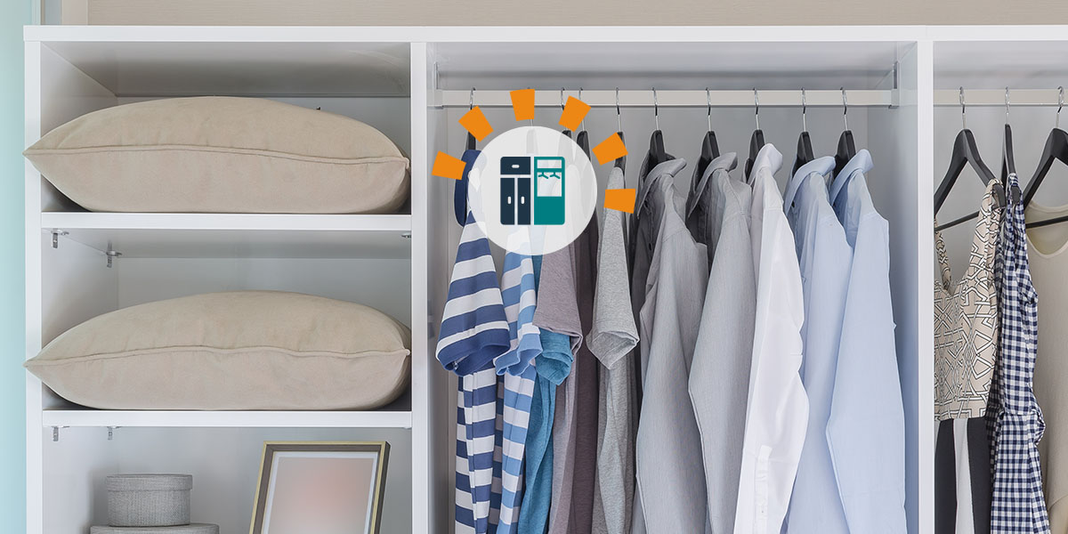 Hanging clothes and other home items neatly organized in a closet.