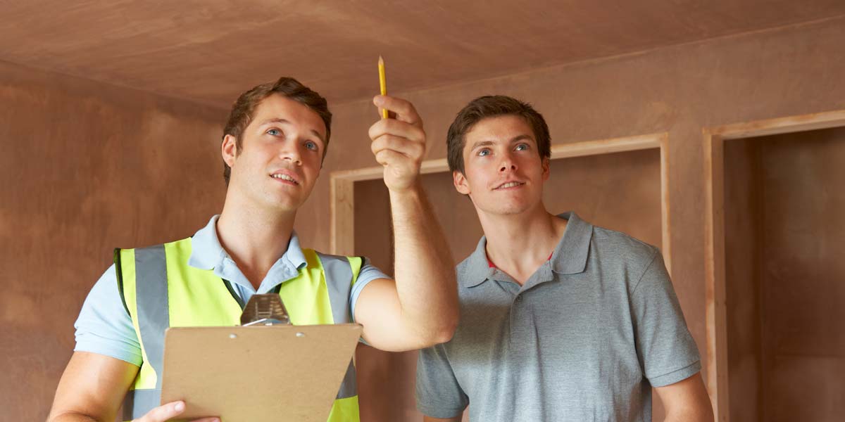 A Home Inspector Pointing Out Potential Repairs to a Home Buyer.