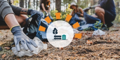 People picking up litter in a wooded area.