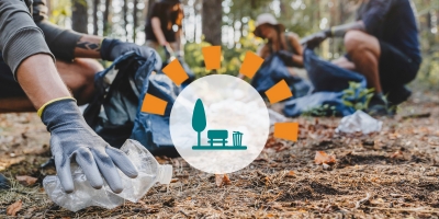 People picking up litter in a wooded area.