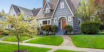 A well-manicured front lawn and flower bed.