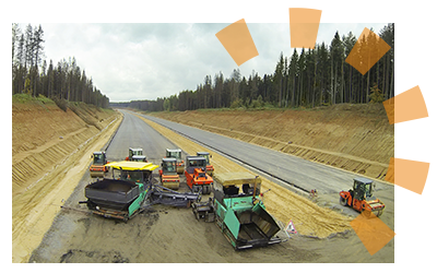 Construction vehicles abandoned at a jobsite as a storm rolls through.