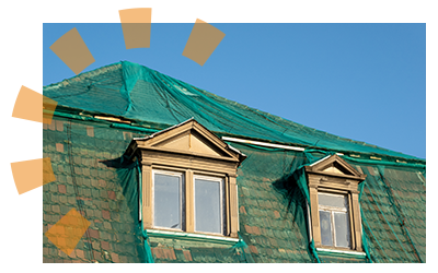 A house covered in netting to catch any materials that blow off during a storm.