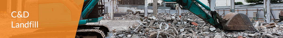 Green excavator machine sorting construction debris at a C&D landfill.