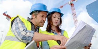 Construction Workers Reviewing Quality Plans