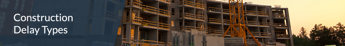 A half-built building on a construction site with a crane in front of it.