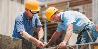 Construction workers dealing with cement framework.