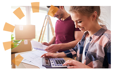 Young couple with paper and calculator at a table budgeting for their bathroom remodel plans.