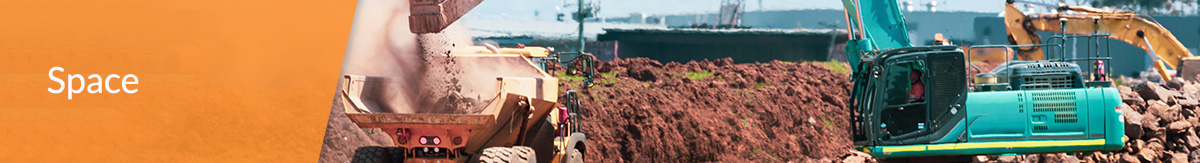 Crane Dumping Dirt Into Machine on Construction Site.