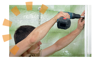 DIYer uses a power drill to detach old metal fixtures from dated shower wall.