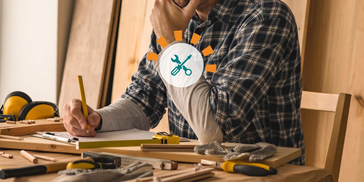 Homeowner planning DIY project surrounded by tools.