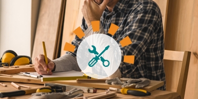 Homeowner planning DIY project surrounded by tools.