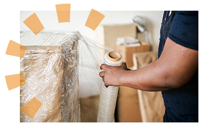 A man wrapping his bedroom furniture to donate it to a local organization. 