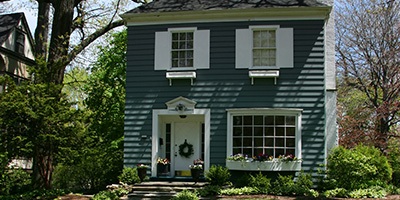Hand Holding Small Home.