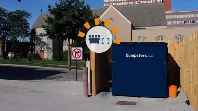 Front Load Dumpster in Wooden Enclosure