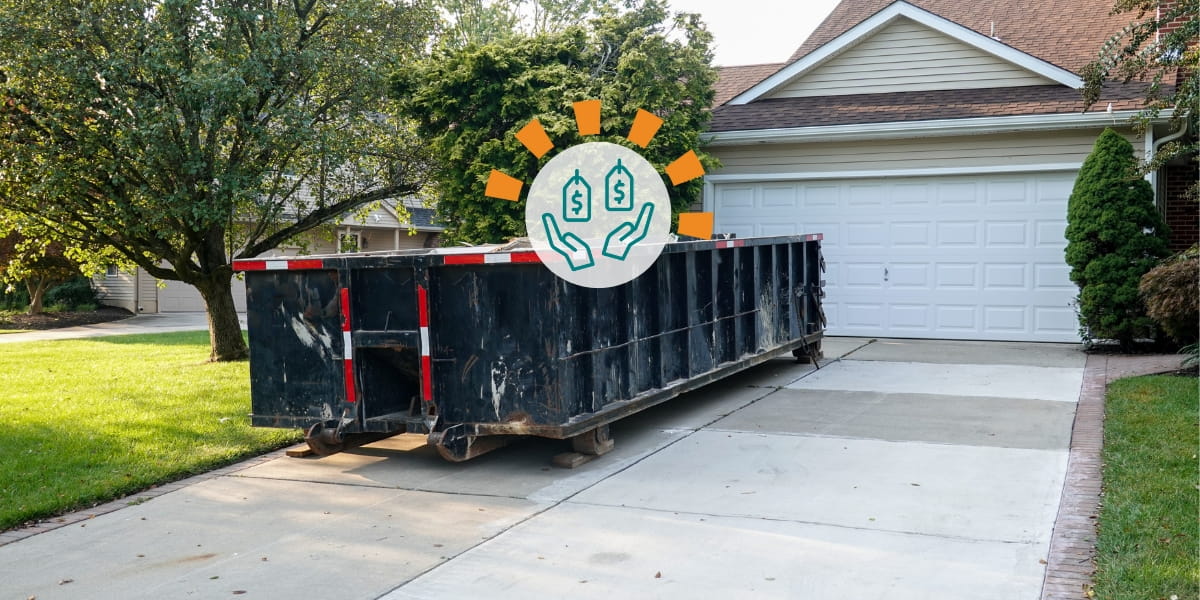Blue dumpster in driveway.