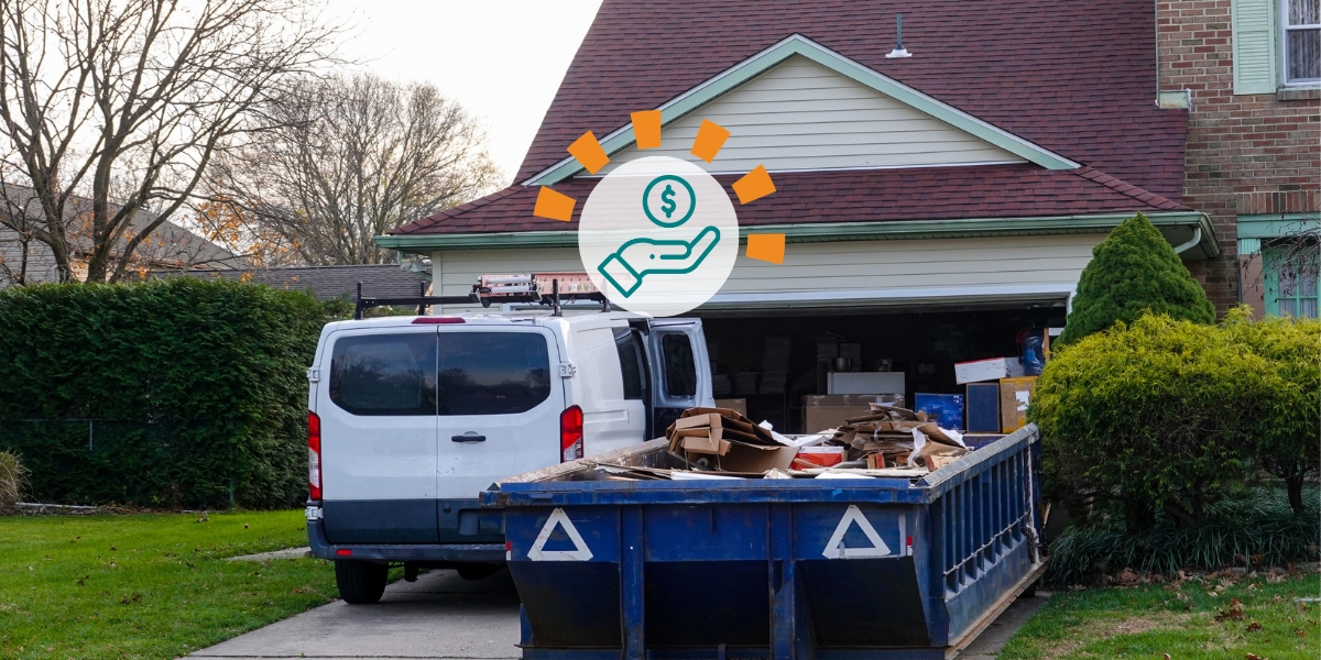 Dumpster filled with debris in driveway next to van.