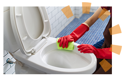 A person in red gloves preparing to sop water out of a toilet with a sponge.