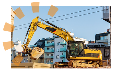 An excavator with home debris.