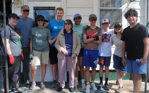 Extreme Community Makeover volunteers standing with community homeowner.